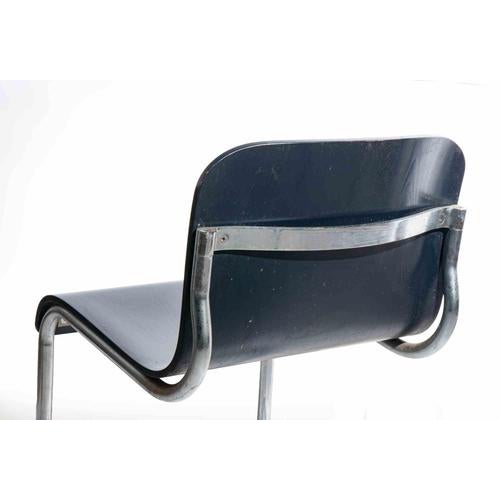 Set of 8 cantilever dining chairs with tubular in chromed steel and seat and back in lacquered wood. A striking set of...
