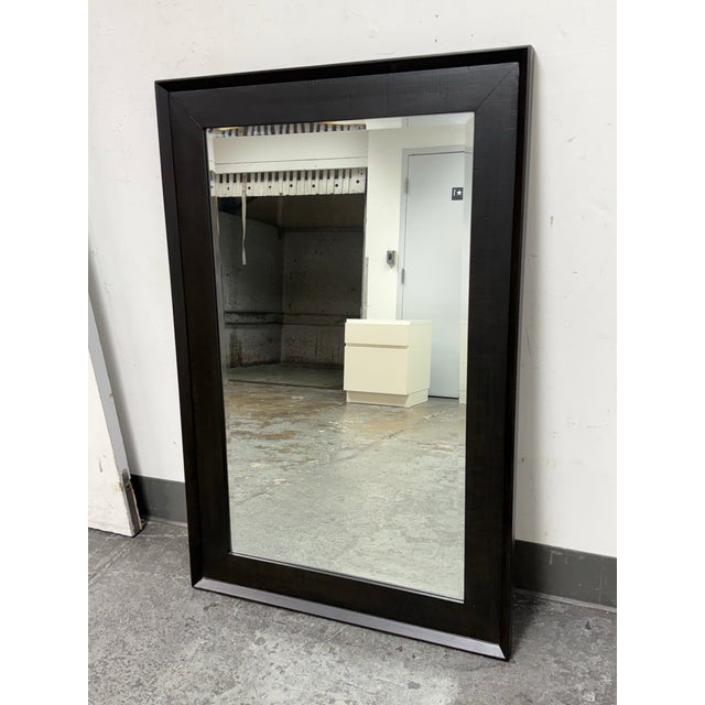 Design Plus Gallery presents a Wall Mirror from Brownstone Furniture. This rectangular mirror has a broad wood frame with...