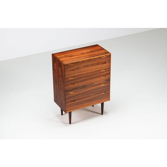 A beautiful tall chest of drawers designed by Svend Langkilde for Langkilde Møbler, Denmark 1960s. Crafted in richly...