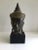 1960s Cast Bronze Crowned Tibetan Buddha Head on Painted Wood Base Face has a meditative expression Half-closed eyes and...
