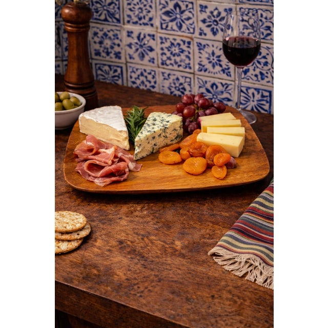 A refined and sculptural pair of handcrafted serving trays made in the United States and signed Blair, Hawaii, carved from...