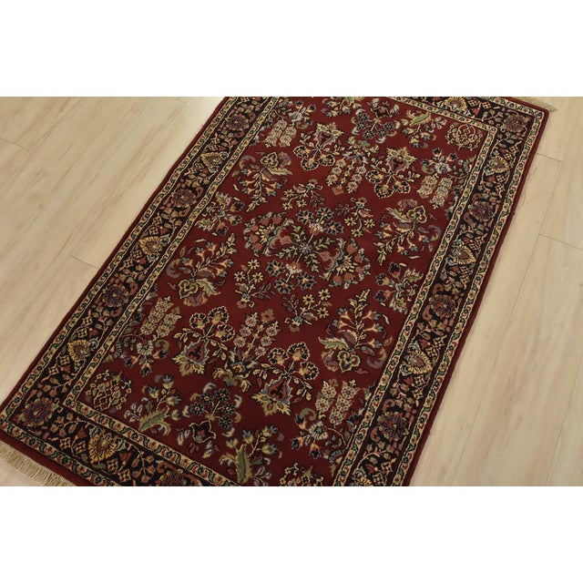 A traditional Sarouk rug hand-knotted with an all-wool pile on a cotton foundation. This finely woven oriental rug...