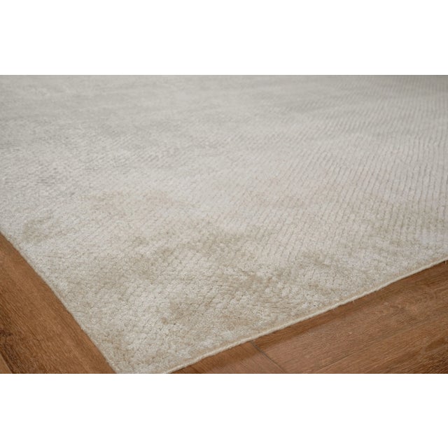 Luxurious and chic, the Pearl rug offers visual intrigue with its textured diamond pattern. Hand loomed with silky...