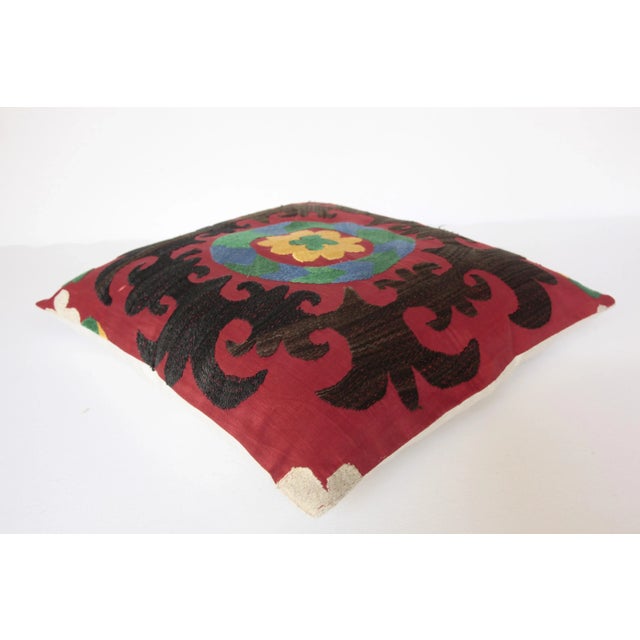 This is a handmade Suzani pillow cover made from old Uzbekistan. It is handmade embroidery and a solid linen back. It's...
