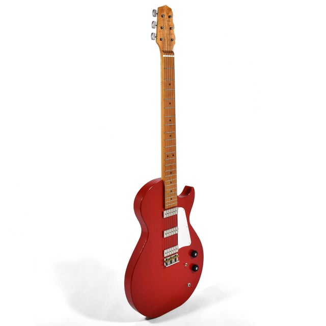This remarkable piece is an oversize decorative Les Paul style guitar that stands over six feet tall. It makes us think of...
