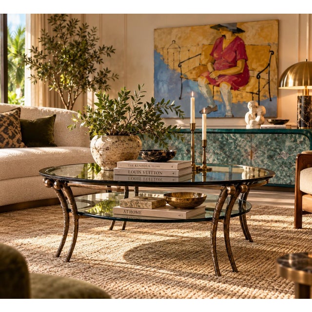 Striking 1980s vintage round coffee table featuring a sculptural hand-hammered metal frame with a beautifully aged bronze-...