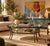 Striking 1980s vintage round coffee table featuring a sculptural hand-hammered metal frame with a beautifully aged bronze-...