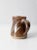 This is a vintage studio pottery pitcher. Signed by the artist, the hand-crafted ewer features a russet brown glaze with...