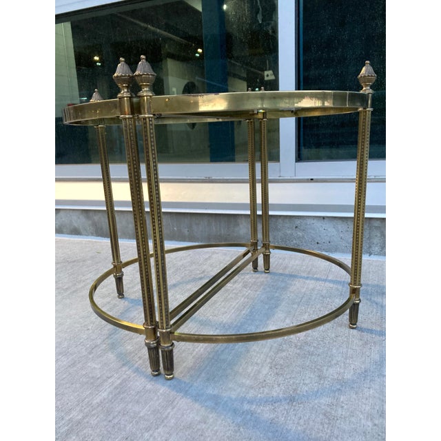 Vintage pair of Neoclassical Jansen style brass, and beveled glass demi-lune end tables with pinecone finials, manner or...