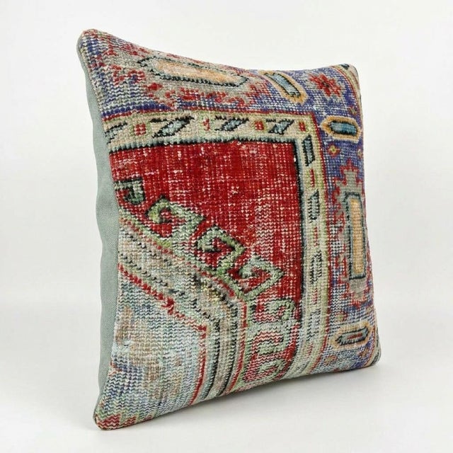This beautiful 20'' x 21'' pillow cover was made from an authentic Turkish rug. Bright colors of wool adorn the front of...