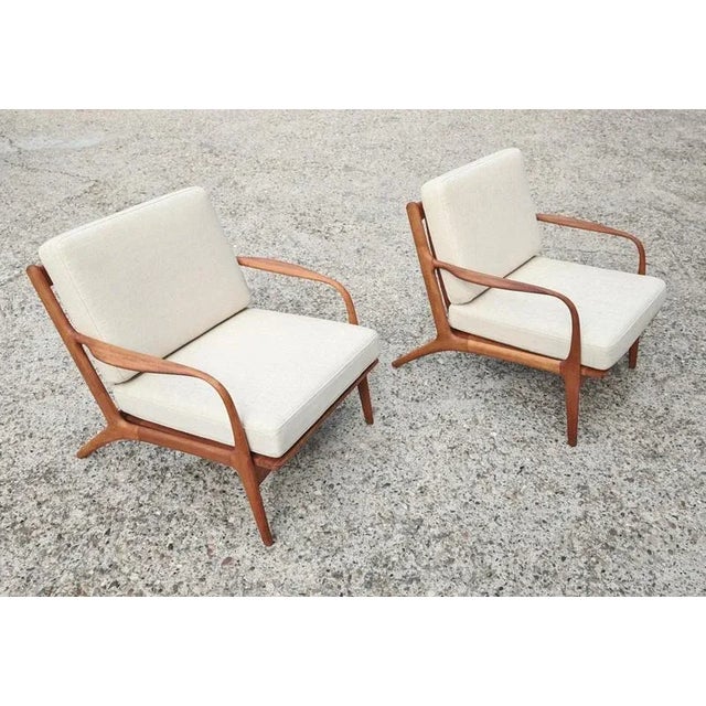 In this listing you will find a pair of stunning armchairs, Model 2315-c. These lounge chairs were designed by Adrian...