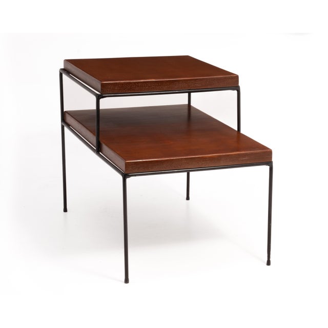 A Planner Group iron and maple tiered side or end table designed by Paul McCobb and made by the Winchendon Furniture in...