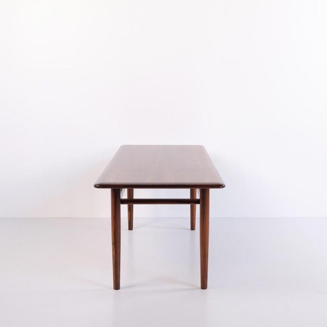 Coffee table crafted from rosewood and manufactured by jason design around 1960. The table features a rectangular top and...