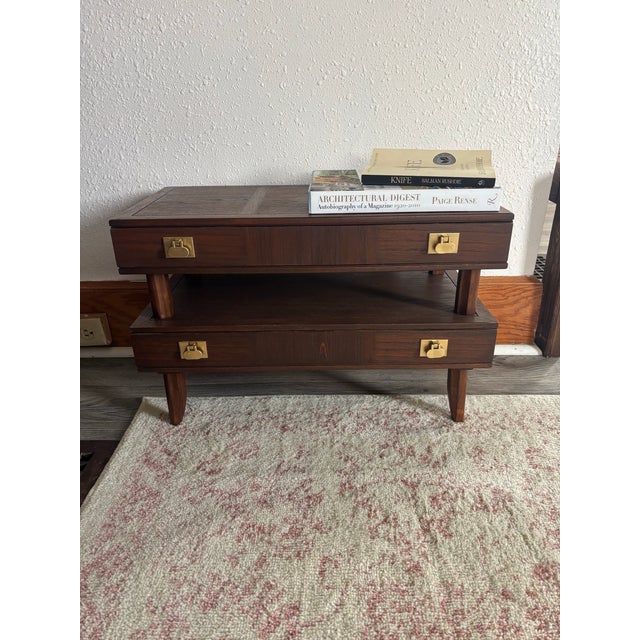 Mastercraft Furniture Co. — Two-Tier Walnut & Brass Campaign Side Table, c. 1950s–60s A beautifully crafted mid-century...