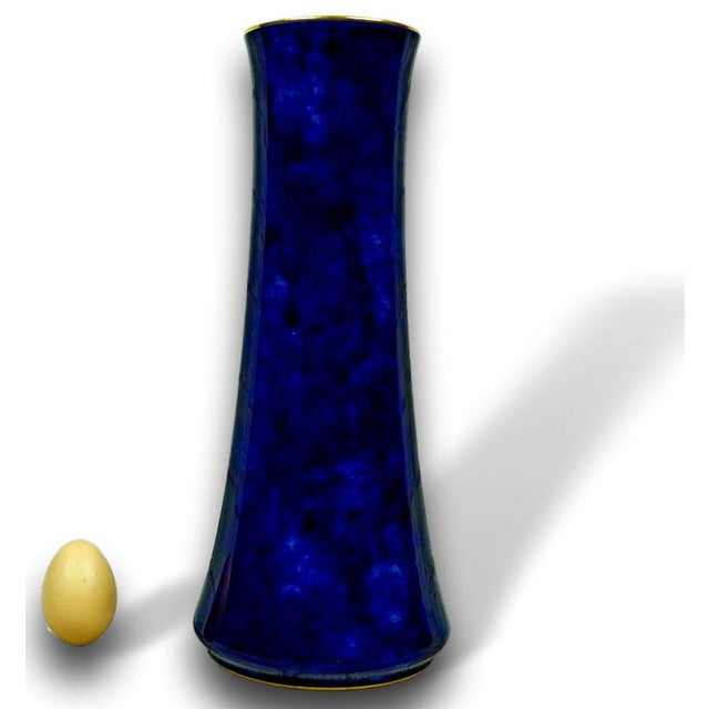 Of tapering conical form, gently concave and narrowing towards the mouth, the vase rests on a slightly projecting circular...