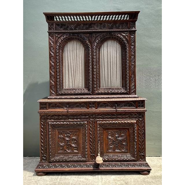 This magnificent 19th-century French "Buffet à Deux Corps" is a masterclass in Gothic Revival craftsmanship, featuring...