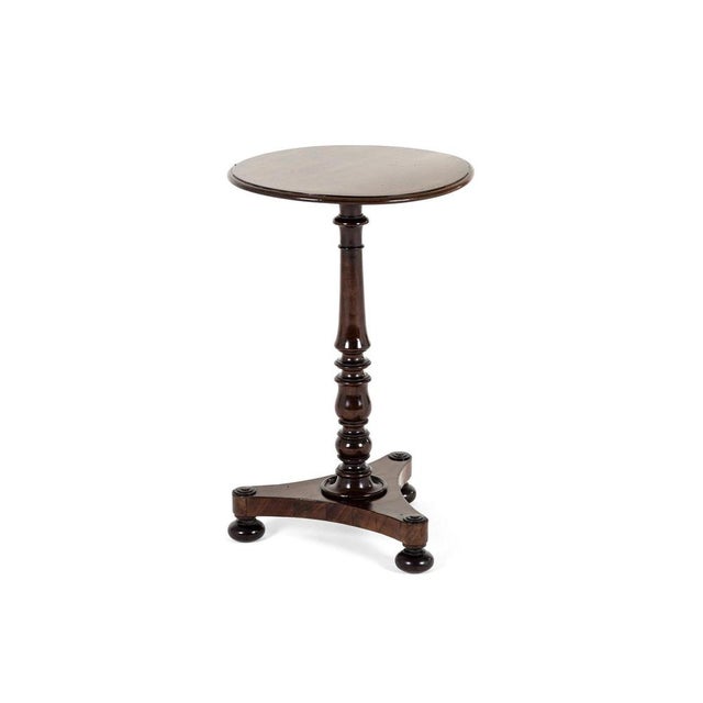 A victorian mahogany wine table or occasional table with a circular top with a gently chamfered edge. The top is supported...