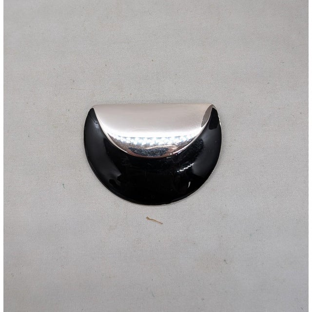 1980s Modernist rhodium plated black enamel brooch which looks like a partially folded circle with security clasp. Marked...