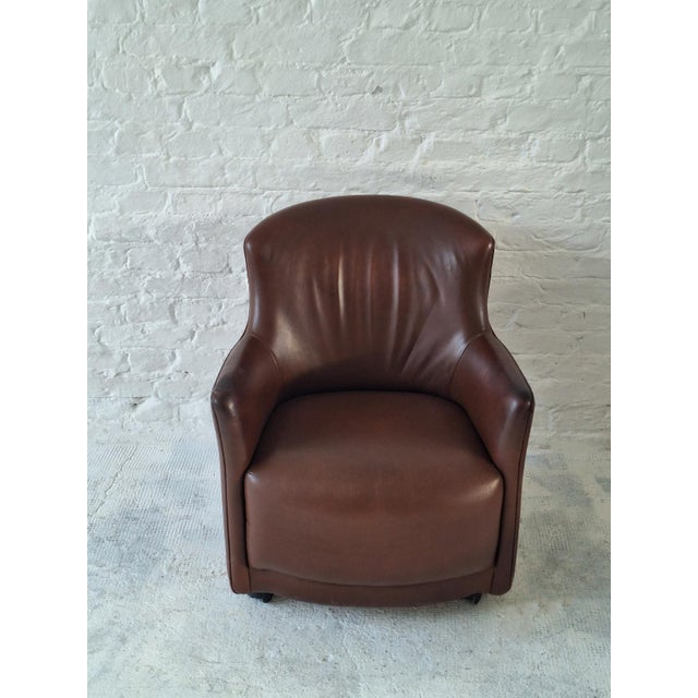 Very attractive compact tub or barrel-shaped club chair with wrap-around backrest and integrated arms, standing on...