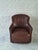 Very attractive compact tub or barrel-shaped club chair with wrap-around backrest and integrated arms, standing on...