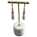 These sophisticated earrings are crafted with a delicate design. Each earring features a teardrop-shaped white agate,...
