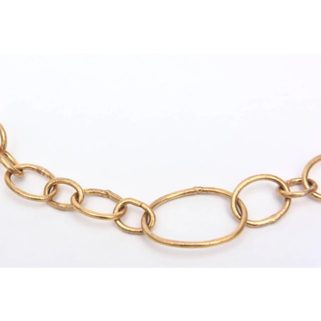 This is part of Chairish’s Fine Jewelry assortment. The asymmetrical aspect of this signed gold filled link/chain necklace...