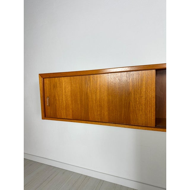 Beautiful vintage mid-century modern floating wall unit by bartels from the 1960s. Elegant minimalist design with warm...