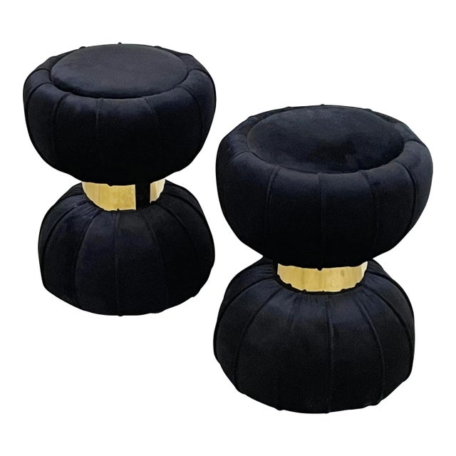 Elegant pair of round round velvet poufs in the shape of an hourglass with central golden metal band. Comfortable padding....