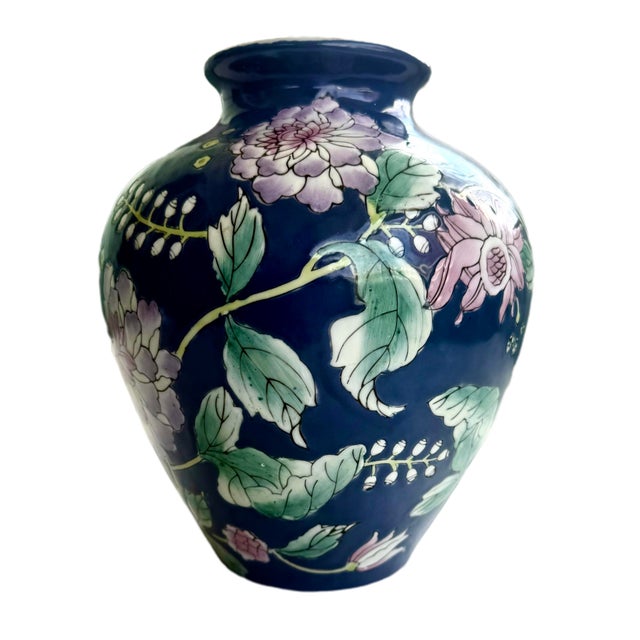 Vintage Chinese porcelain vase, decorated with peonies and other flowers in a pink and white motif against a deep cobalt...