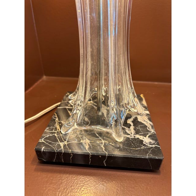 An exceptional Art Deco table lamp in blown crystal and brass, produced by the French glassmaker Cofrac Art Verrier. This...