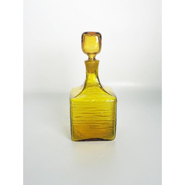 Decorative French glass bottle dating from the 1970s, featuring a striking yellow-amber color and its original matching...
