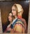 A stunning 19th century orientalist oil portrait painting of two beautiful young women in colorful garments. It is signed...