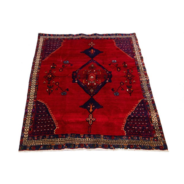 Vintage wool rug Persian Shiraz Handmade with a red field. Has a multicolor medallion motif. This rug measures 5'9" x 7'11".