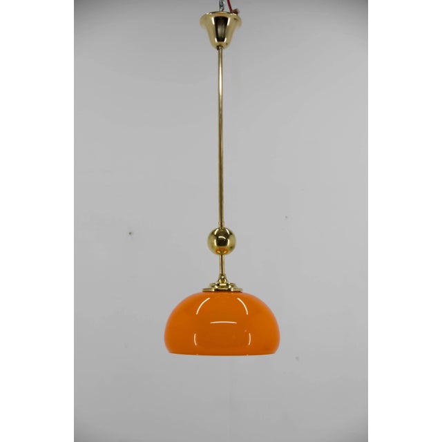 Orange pendant made in Czechoslovakia in 1980s. Restored: brass refinished and polished. Orange glass without any damage....