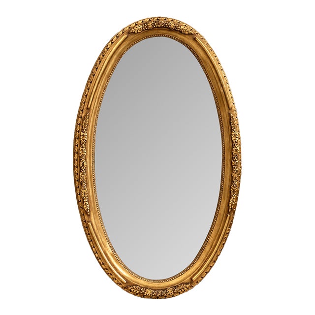French-Style Oval Wall Mirror – Ornate Gold Leaf Frame With Floral Center Ornament For Sale