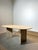This elegant vintage dining table is crafted entirely from natural travertine, featuring an oval top with beautiful...