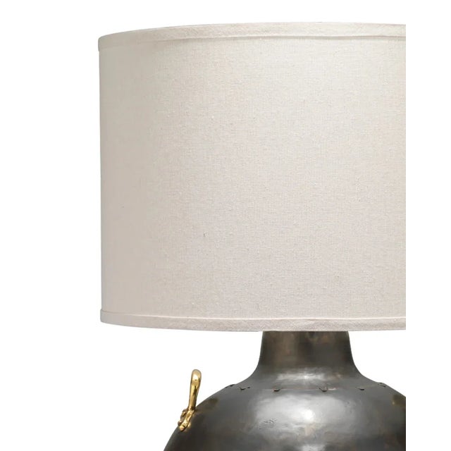 Elevate your decor with a hint of refinement using this distinctive metal table lamp. Boasting an iron-finished base...