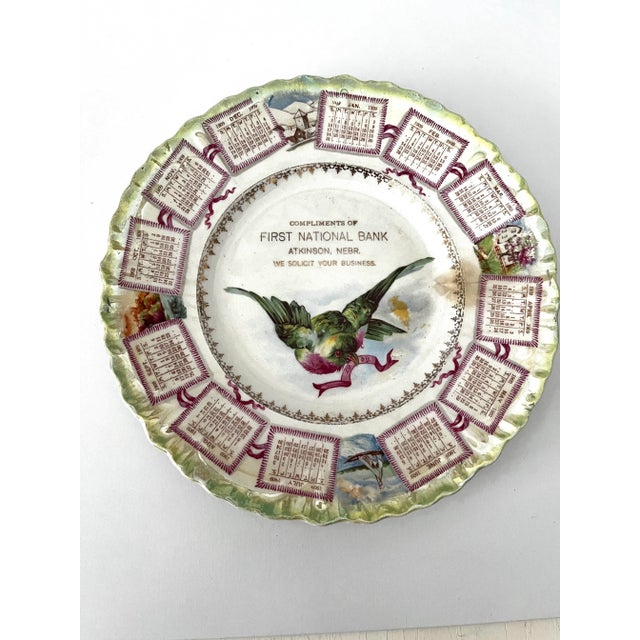 Marvelous 1909 antique calendar plate. Ceramic with ruffled edges showing a green and fuschia bird. Marked from First...