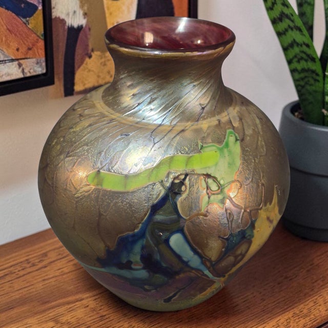 This Vintage Studio Hand Blown Iridescent Art Glass Vase is a stunning piece of abstract art glass from the late 20th...