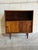 This elegant mid-sized Bookcase features an upper open display shelf sitting directly above a lower sliding door cabinet....