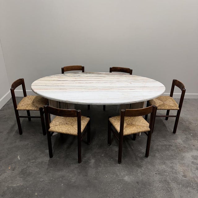 A spectacular 1970s Italian oval dining table crafted in Arabescato Rosso marble — a highly decorative marble known for...
