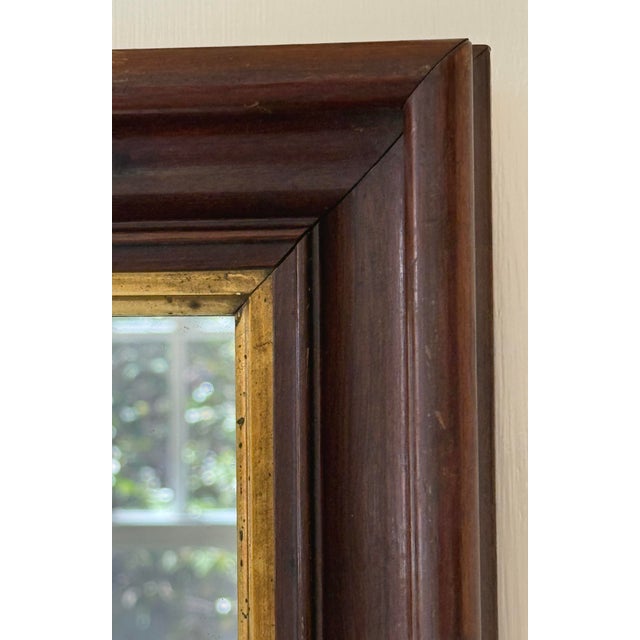 Beautiful Early 20th Century American Antique Walnut Wood with Gold Gilt Framed Wall Mirror. This lovely mirror would make...