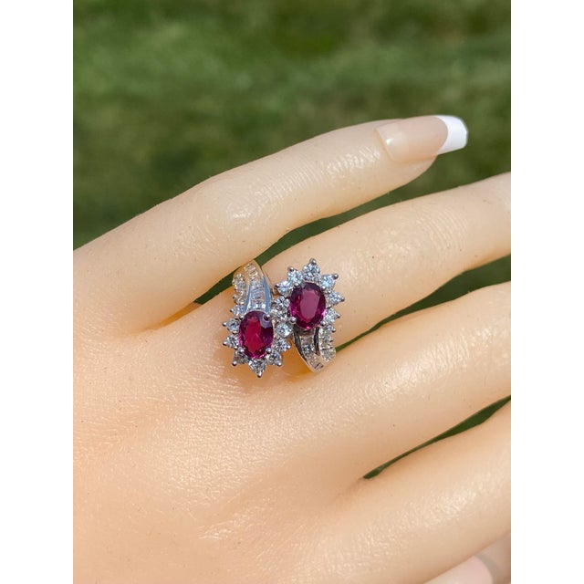 The East Lake Drive: Natural Double Ruby Bypass Ring with Diamonds. This exceptional ring showcases a duo of alluring...