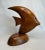 The clean lines and shape enhance this solid wood sculpture of an Angelfish. With painted eyes and drilled holes on the...