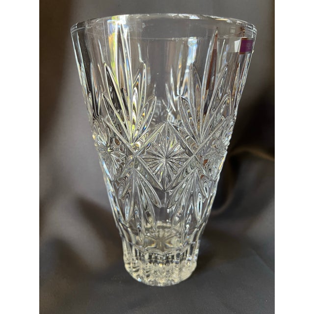 A beautifully cut Marquis by Waterford “Raymond” crystal vase, featuring bold geometric wedge cuts and intricate starburst...