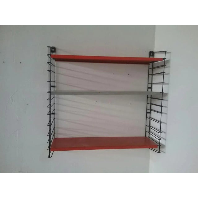 This shelving unit was produced by Tomado in Holland in the 60s.