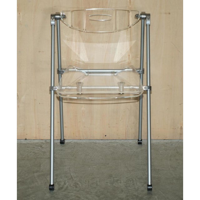 This is a very cool over engineered acrylic glass and steel folding chair with swinging back rest A very well made chair,...