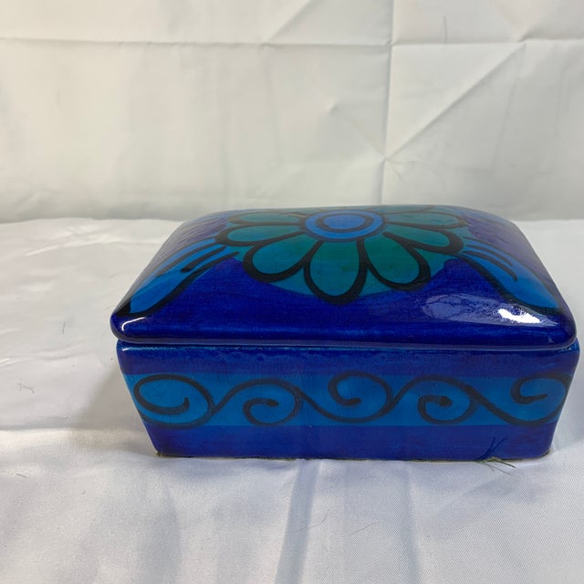 This item is a vintage mid-century modern ceramic lidded trinket box featuring an abstract floral motif, commonly...