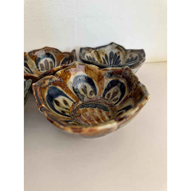 Beautiful set of 7 Ken Edwards lotus bowls each with hand-painted blue and brown floral patterns. These pieces were made...