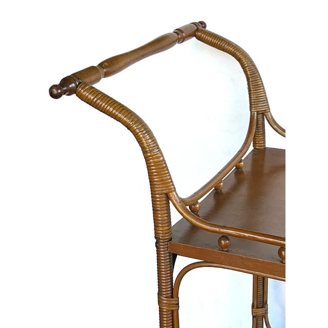 the two-wheeled drinks trolley with turned handle joining a rectangular top within an openwork gallery all raised on...